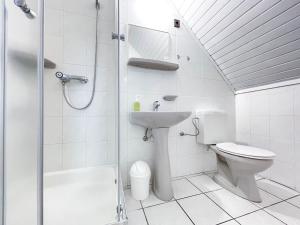 a bathroom with a toilet and a sink and a shower at Manna Villa in Balatonfüred