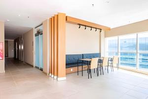 a conference room with a table and chairs and a large window at Hotel VISION in Brasilia