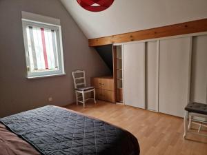 Tempat tidur dalam kamar di Gîte Alsace en vue