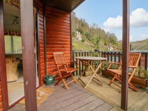 a patio with two chairs and a table on a porch at 22 Two Little Ducks in Lynton +7 photos