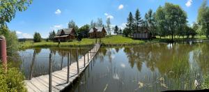 a bridge over a river with houses and trees at Domek wakacyjny nr 2 in Giżycko