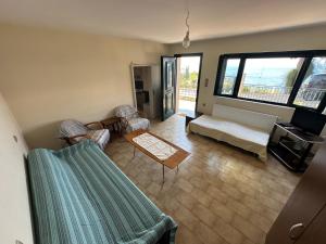 a living room with a couch and a table at Marble Home in Egira