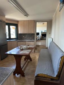 a kitchen with a table and a couch in a room at Marble Home in Egira