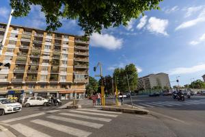 a city street with a building and a crosswalk at Radio Hotel in Rome