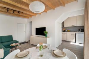 a kitchen and living room with a table and chairs at Morze Ciszy in Dziwnów
