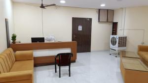 a living room with a couch and a desk at Rajwada Palace and Marriage Garden in Saipur +6 photos