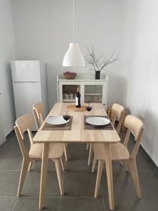 a wooden table and chairs in a kitchen at Luxury apartment close to everything in Granada +18 photos