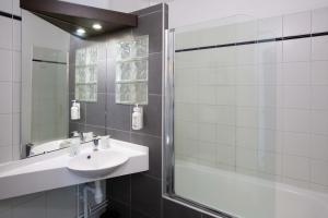 a bathroom with a sink and a shower at HOTEL l'EAUBONNE in Eaubonne +49 photos