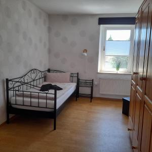 a small bedroom with a bed and a window at Haus am Berg in Üdersdorf