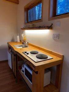 a kitchen with a counter with a stove and a sink at La Venecia Cabañas in San Rafael +4 photos