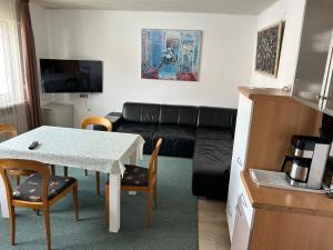 a living room with a couch and a table at Apartment am Rathaus 3SZ in Rödermark +9 photos