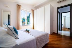Postel nebo postele na pokoji v ubytování Ermes by PortofinoHomes