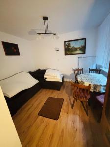 a room with two beds and a table in it at VILLA BIAŁA in Okuninka +16 photos