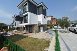 a house with a black and white facade at Villa Begonvil in Kusadası
