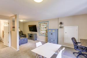 a living room with a table and chairs at Spacious Eagle River Escape with Hot Tub and Views! in Eagle River