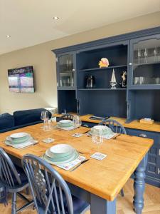 a dining room with a wooden table and chairs at Victoria Cottage, Cullercoats in Cullercoats