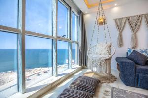 a living room with a hanging chair and large windows at Skyline Premium Properties in Alexandria