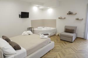 a bedroom with a bed and a sink and a chair at B&B Nanze' e Rete' - Esperienze Pugliesi in Carosino +37 photos