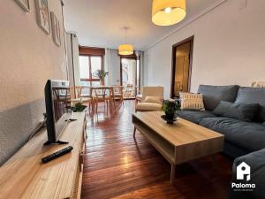 a living room with a couch and a table at FN231 El Cuco in San Vicente de la Barquera