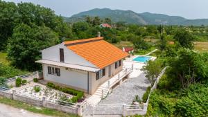 an aerial view of a house with an orange roof at Holiday House Ivan with heated pool in Neorić