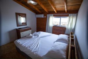a bedroom with a white bed and a window at Calme Beach in Vlorë +28 photos