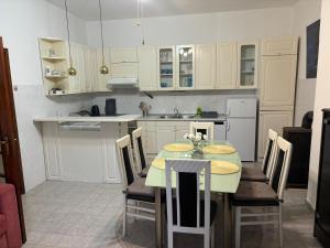 a kitchen with a table and chairs in it at Apartments Renata in Pučišća