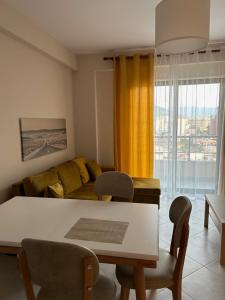 a living room with a table and a couch at Water Lily Apartments in Vlorë +24 photos