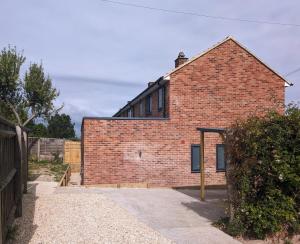 a red brick house with a pathway leading to it at Derwent Avenue self-contained apartments in Headington in Oxford