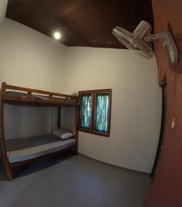 a room with two bunk beds and a window at C U Hostel in Trincomalee
