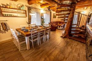 a dining room with a wooden table and chairs at Chalupa Katka in Dolný Kubín