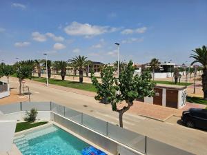 a swimming pool with a tree in the middle of a street at Holiday Home KyDo - Heated Pool - Roof Terrace - San Pedro del Pinatar in San Pedro del Pinatar