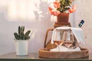 a tray with two glasses of wine on a table at Loft Poerio Ostuni in Ostuni +22 photos