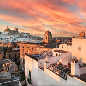 a view of a city at sunset at Loft Poerio Ostuni in Ostuni