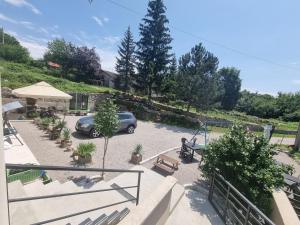 a car parked in a parking lot with plants at Haus Natura in Jurdani