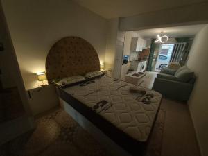 a bedroom with a large bed and a living room at Apartamento MOTA 8 in Xeraco