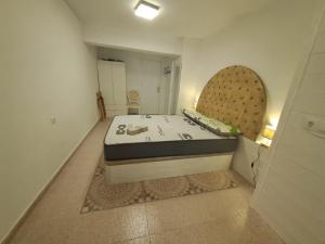 a small room with a bed and a mirror at Apartamento MOTA 8 in Xeraco +2 photos