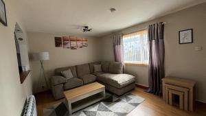 a living room with a couch and a table at Seasgair House in Balivanich