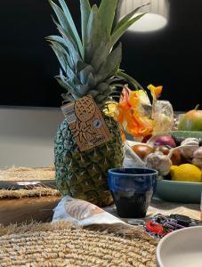 a pineapple sitting on top of a table with fruit at Morze, Basen&SPA i Spokój Apartament 2 Pięć Mórz w Sianożętach in Sianozety