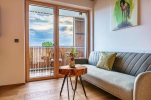 a living room with a couch and a table at Hotel Frost in Maribor