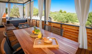 a table on a balcony with a view of the beach at Luxury and Cosy Little House Ivinj 1 in Tisno