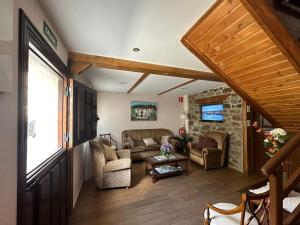 a living room with a couch and a table at Casa Amparo in Pajares