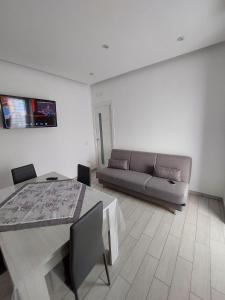 a living room with a couch and a table at Gaia Pia Home in Bacoli +15 photos