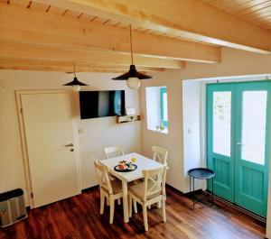a dining room with a white table and chairs at Lassini in Mali Lošinj