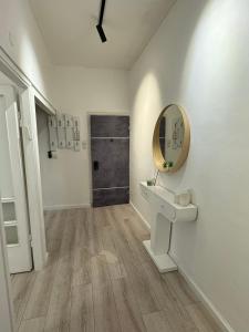 a bathroom with a sink and a mirror on the wall at 3 rooms apartment on the beach in Tel Aviv