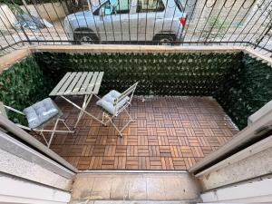an overhead view of a patio with a bench and chairs at 3 rooms apartment on the beach in Tel Aviv