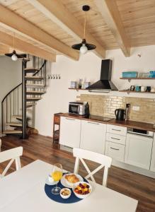 a kitchen with a table with plates of food on it at Lassini in Mali Lošinj +25 photos