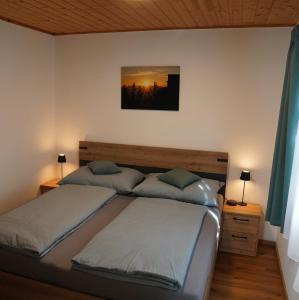a bedroom with two beds and a painting on the wall at Ferienhaus Romantika in Bad Aussee