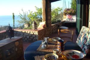 a table with plates of food on a patio at Elba stunning sea view private peaceful property in La Guardia