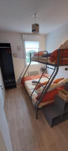 a bedroom with two bunk beds and a window at LouEva in Mimizan +6 photos