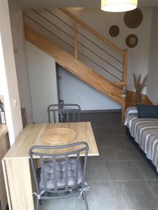 a table and chairs in a room with a couch at LouEva in Mimizan